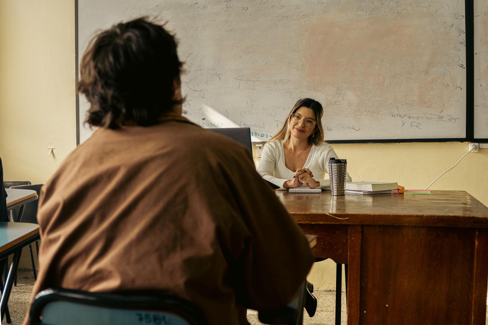 School administrator working with financial documents at a desk.
