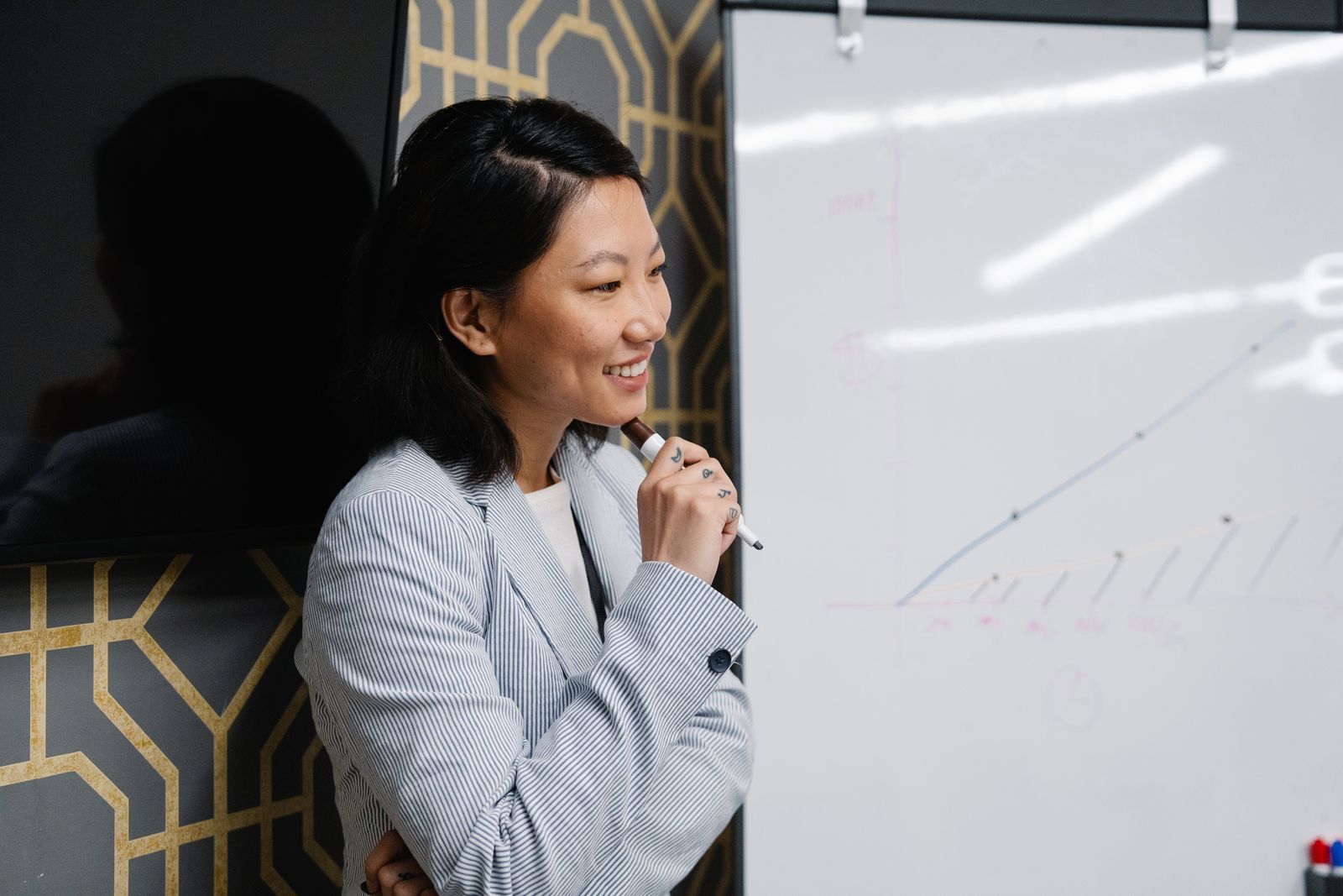 Operational leader mapping a workflow on a whiteboard with the team looking on.