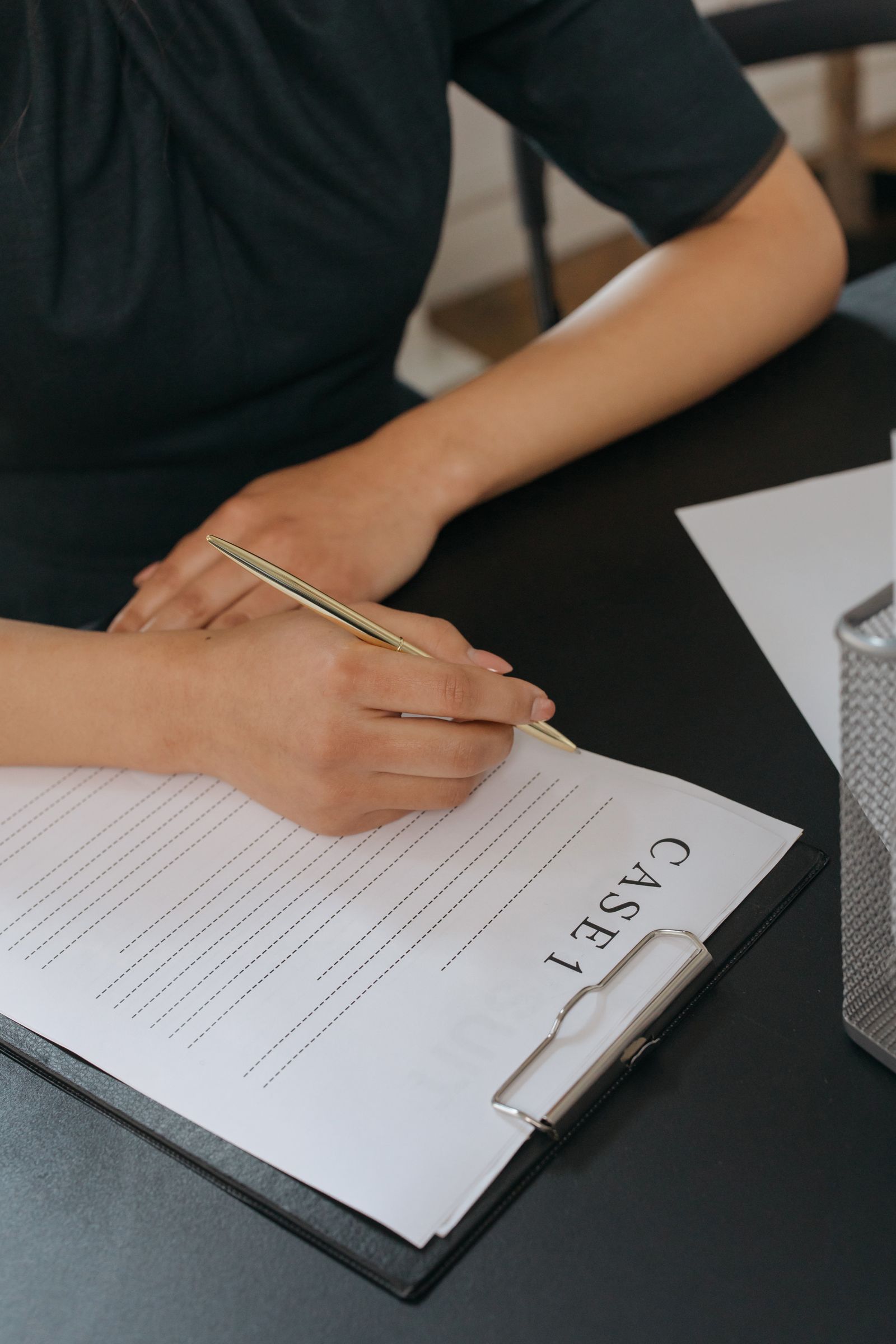 Researcher reading through grant documents and taking notes at a desk.