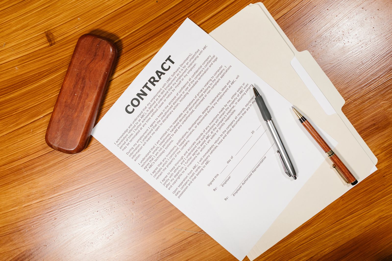 Government contract documents and a pen on an office desk.