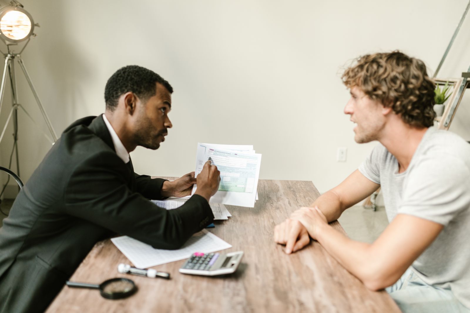 Nonprofit advisor reviewing financial charts alongside an executive at a conference table.
