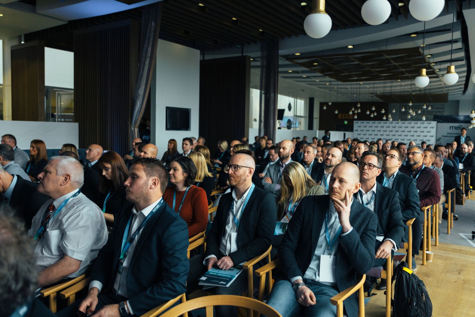 Large professional audience seated during an association conference.